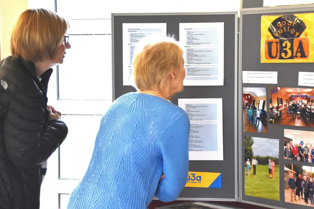 Members studying a poster display